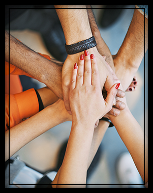 students hands in huddle