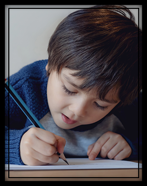 young boy with a paper and pencil
