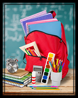 School backpack on desk with school supplies